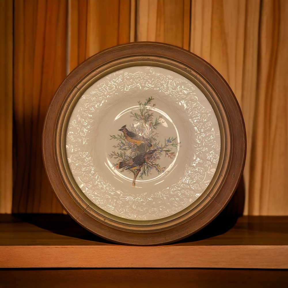 Vintage dinner plate mounted in a wooden frame for wall hanging.